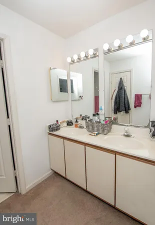 a bathroom with a double vanity sink and a mirror