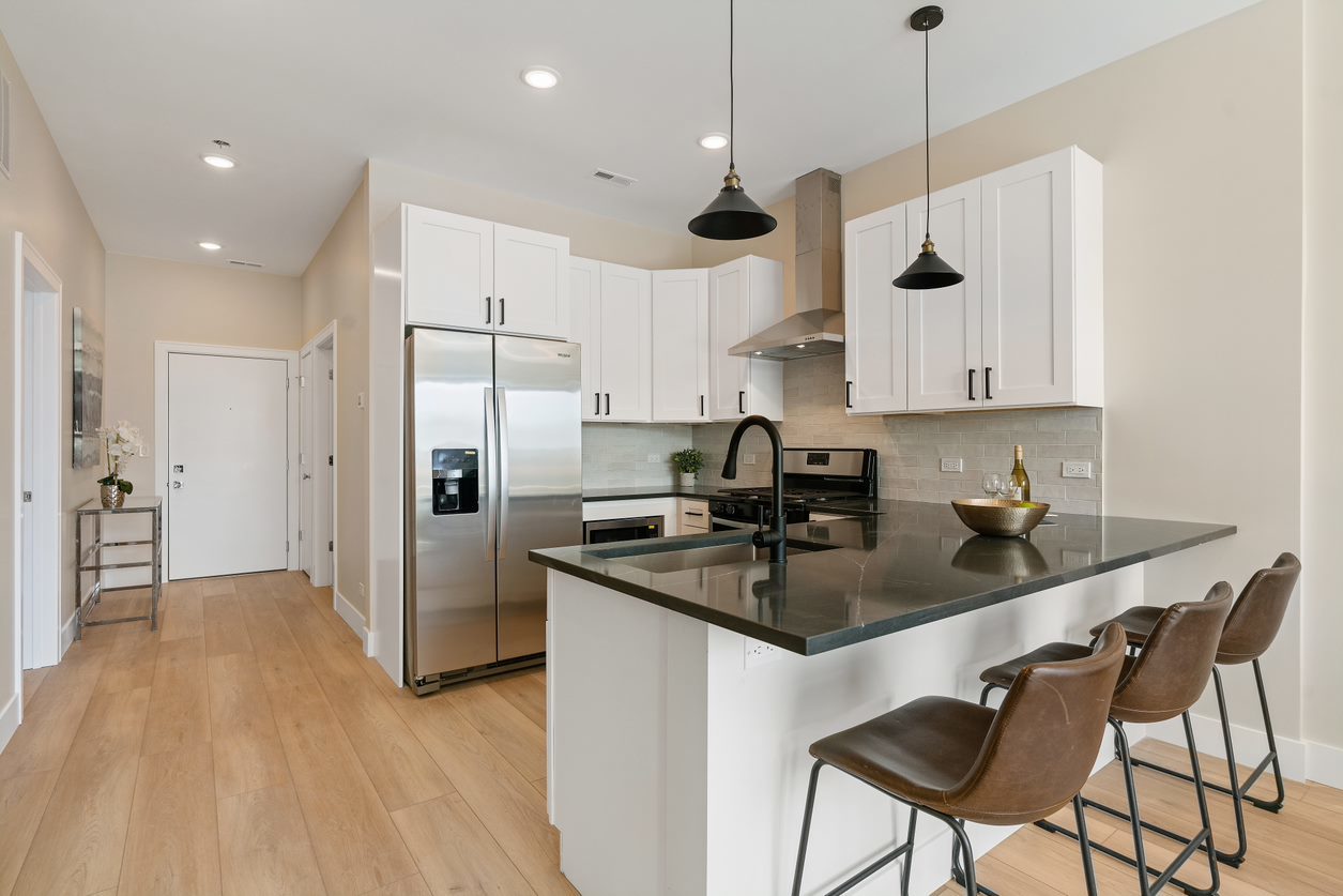 Undisclosed Address Chicago, IL 60657 - Photo 11 of 22 a kitchen with stainless steel appliances granite countertop a sink a stove a refrigerator and island with wooden floor
