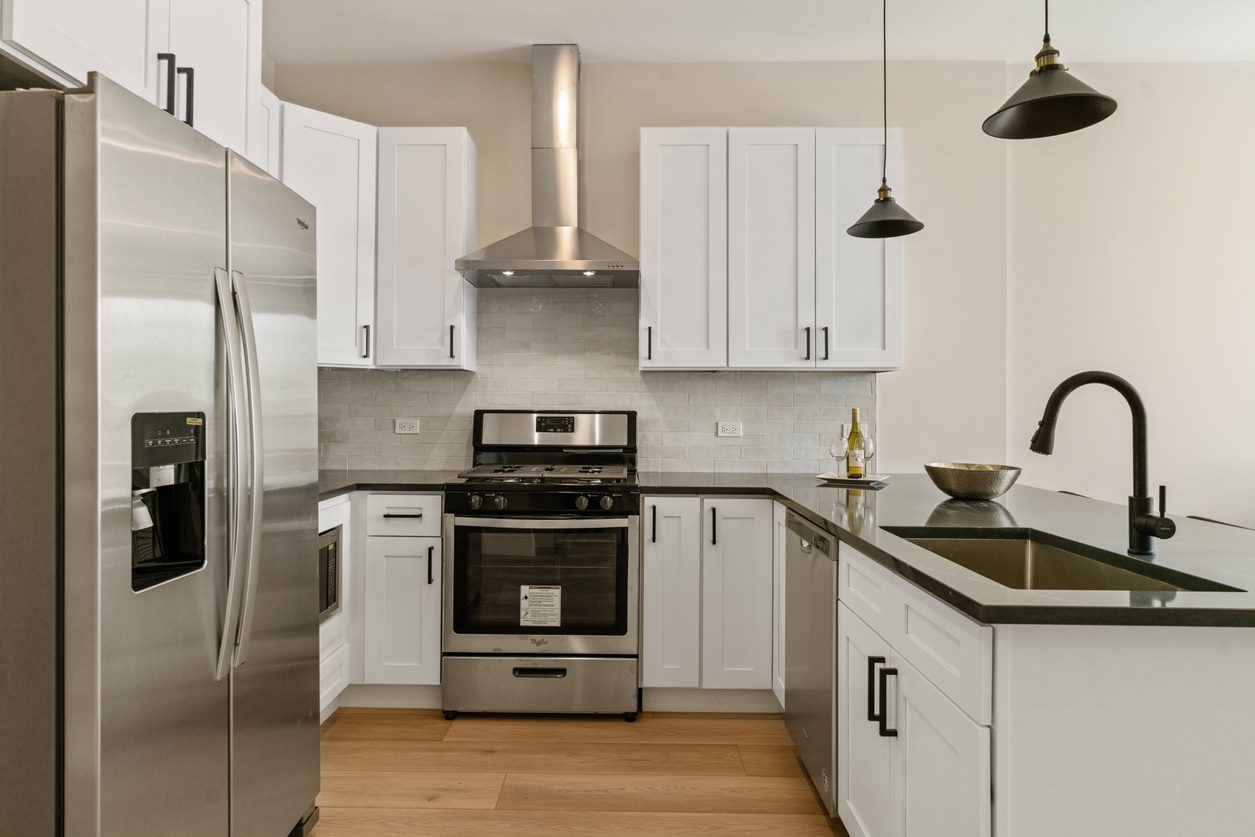 Undisclosed Address Chicago, IL 60657 - Photo 12 of 22 a kitchen with stainless steel appliances granite countertop a refrigerator a sink a stove and white cabinets