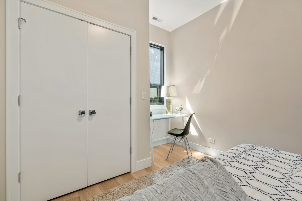 Undisclosed Address Chicago, IL 60657 - Photo 16 of 22 a room that has a bed and a chair in it