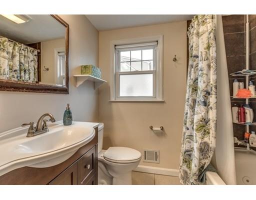 108 Chesbrough Road Boston, MA 02132 - Photo 14 of 22 a bathroom with a sink a toilet and shower curtain