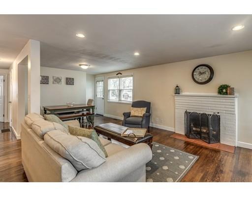 108 Chesbrough Road Boston, MA 02132 - Photo 7 of 22 a living room with furniture a clock and a fireplace