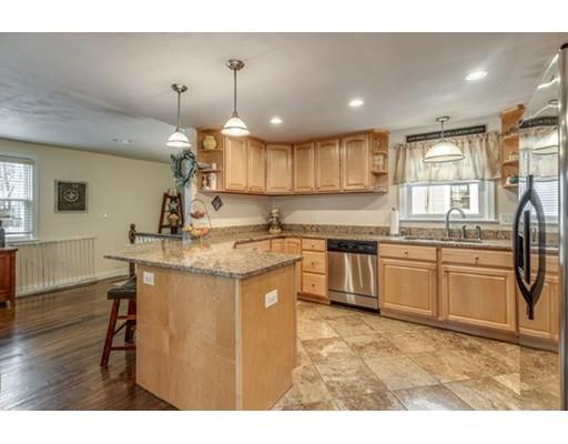 108 Chesbrough Road Boston, MA 02132 - Photo 9 of 22 a kitchen with stainless steel appliances granite countertop a sink a stove a refrigerator and island with wooden floor