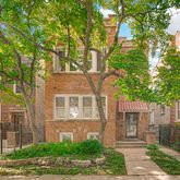 front view of a house with a tree