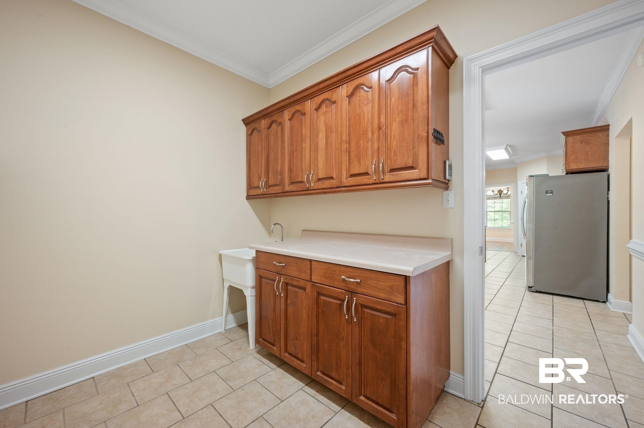 2041 Ridgeline Drive Mobile, AL 36695 - Photo 18 of 43 Kitchen featuring stainless steel refrigerator, light tile patterned floors, and crown molding