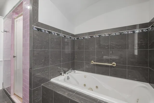 a bathroom with a bathtub and a shower