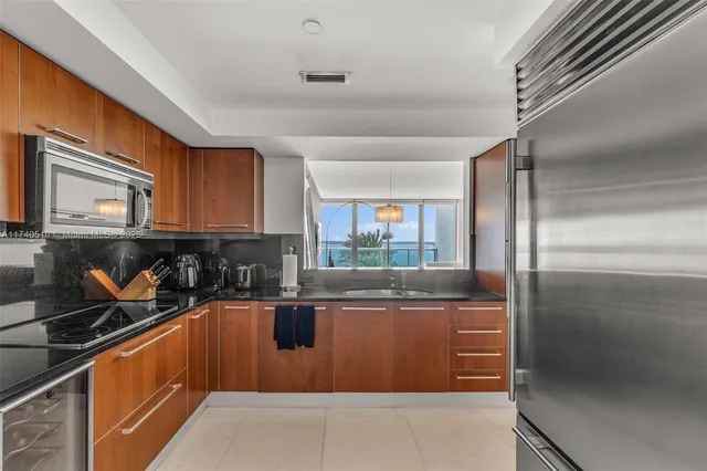 a kitchen with stainless steel appliances granite countertop a refrigerator and a stove
