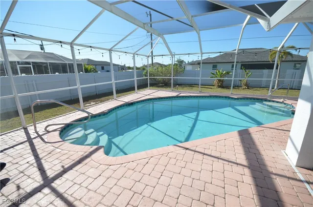a view of a backyard with a swimming pool
