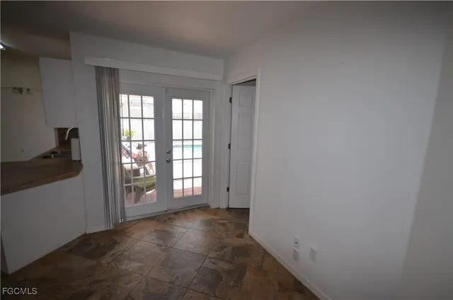 a kitchen with sink and refrigerator