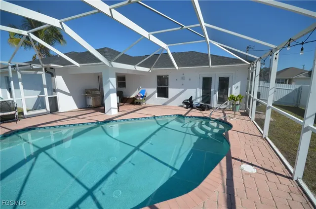a view of a patio with table and chairs under an umbrella