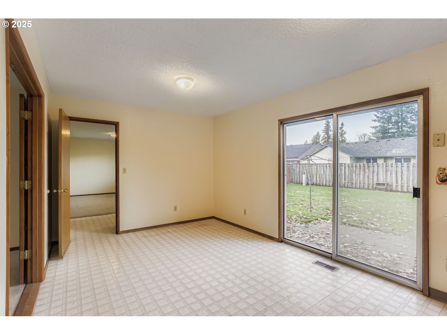 1134 South Ginger Street Cornelius, OR 97113 - Photo 9 of 25 a view of an empty room with wooden floor and a window