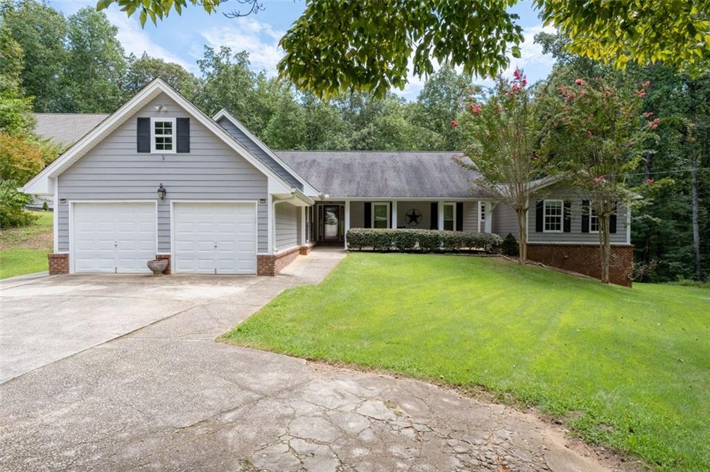 4692 Yeager Road Douglasville, GA 30135 - Photo 1 of 1 a front view of a house with a garden