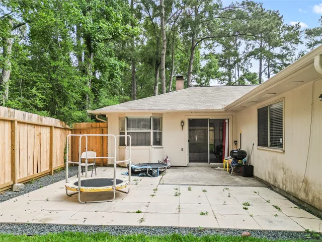 a view of a patio with table and chairs with wooden fence and plants