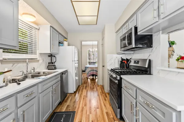 a kitchen with stainless steel appliances granite countertop a stove and a sink