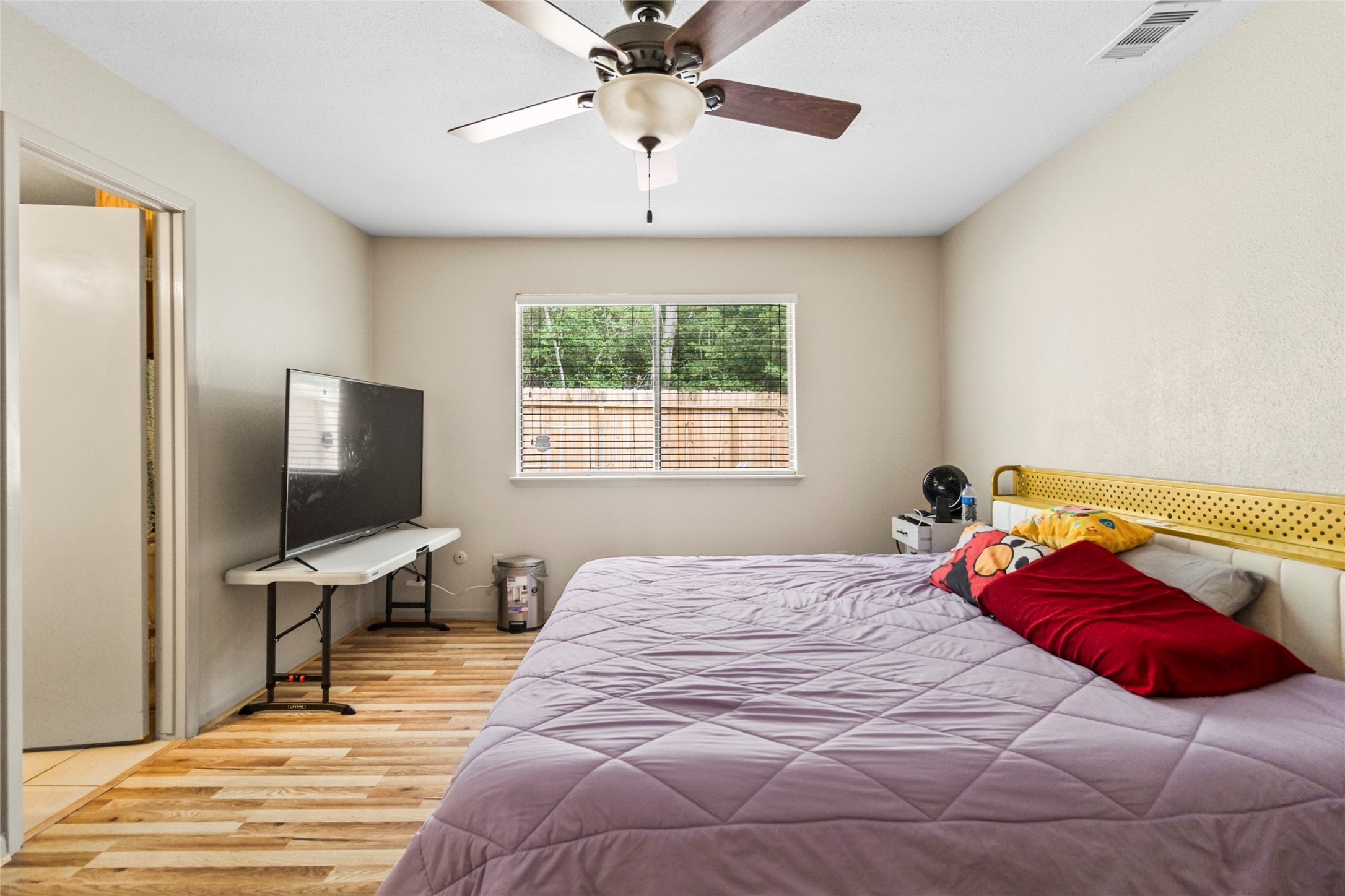 1 East Woodtimber Court Spring, TX 77381 - Photo 8 of 16 a bedroom with a large bed and tv