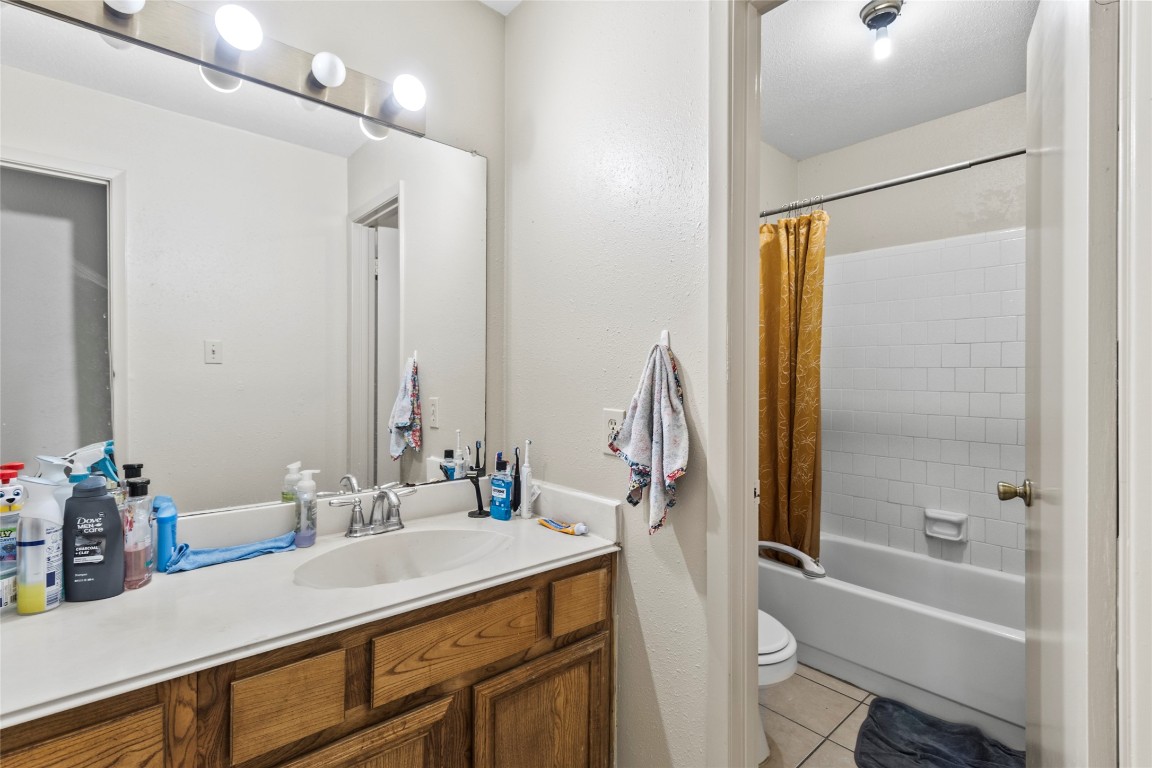 1 East Woodtimber Court Spring, TX 77381 - Photo 10 of 16 a bathroom with a tub sink vanity and a mirror
