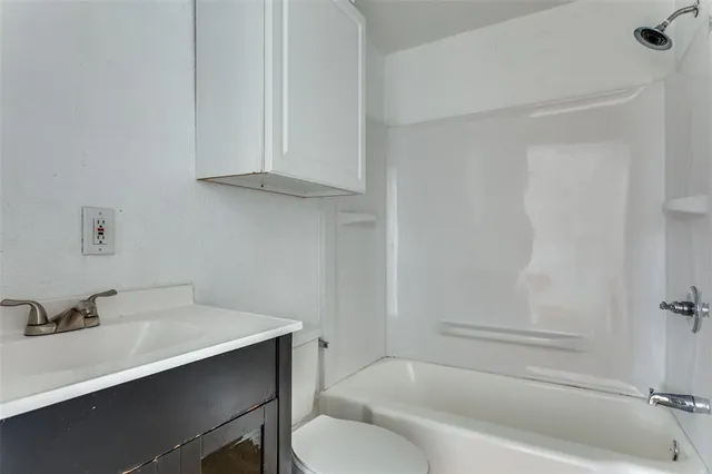 a bathroom with a sink a toilet and bathtub