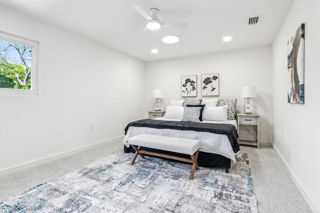 a bedroom with a bed and a painting on the wall