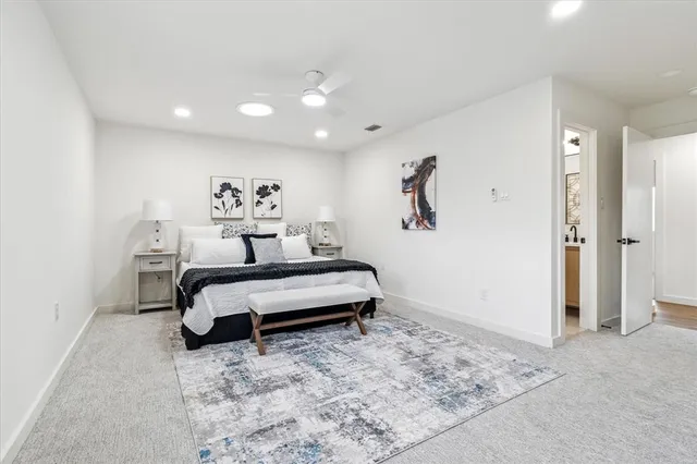 a bedroom with a bed and a painting on the wall