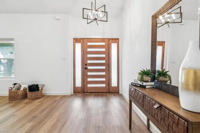 a view of a room with wooden floor and windows