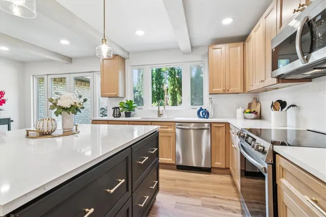 a kitchen with a sink stove and cabinets
