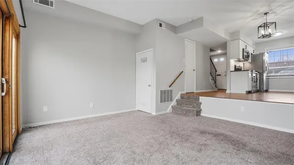a view of a kitchen with a refrigerator and a sink