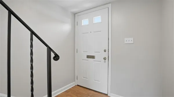 a view of an entryway with wooden floor