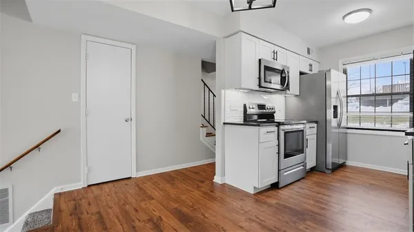 a kitchen with stainless steel appliances a white stove top oven and a refrigerator