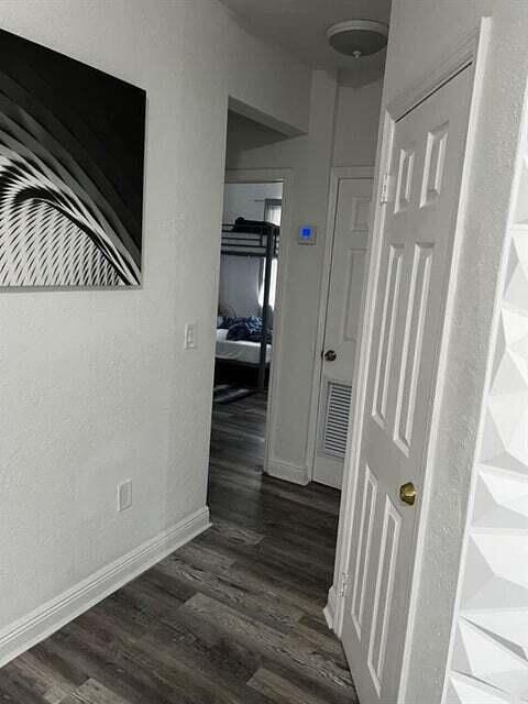 538 Southwest 7th Street Hallandale Beach, FL 33009 - Photo 12 of 17 a view of a hallway with wooden floor and staircase