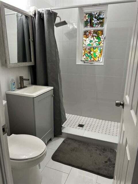 538 Southwest 7th Street Hallandale Beach, FL 33009 - Photo 13 of 17 a bathroom with a sink toilet and vanity