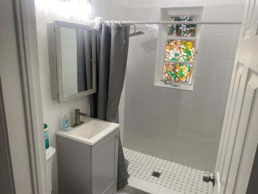 538 Southwest 7th Street Hallandale Beach, FL 33009 - Photo 14 of 17 a bathroom with a sink and a shower curtain