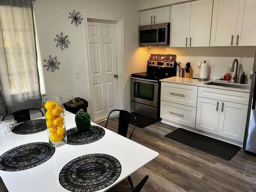 538 Southwest 7th Street Hallandale Beach, FL 33009 - Photo 15 of 17 a kitchen with a refrigerator and a stove top oven