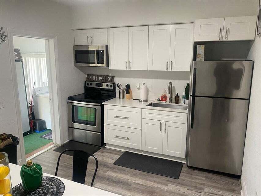 538 Southwest 7th Street Hallandale Beach, FL 33009 - Photo 16 of 17 a kitchen with stainless steel appliances a refrigerator stove microwave and sink
