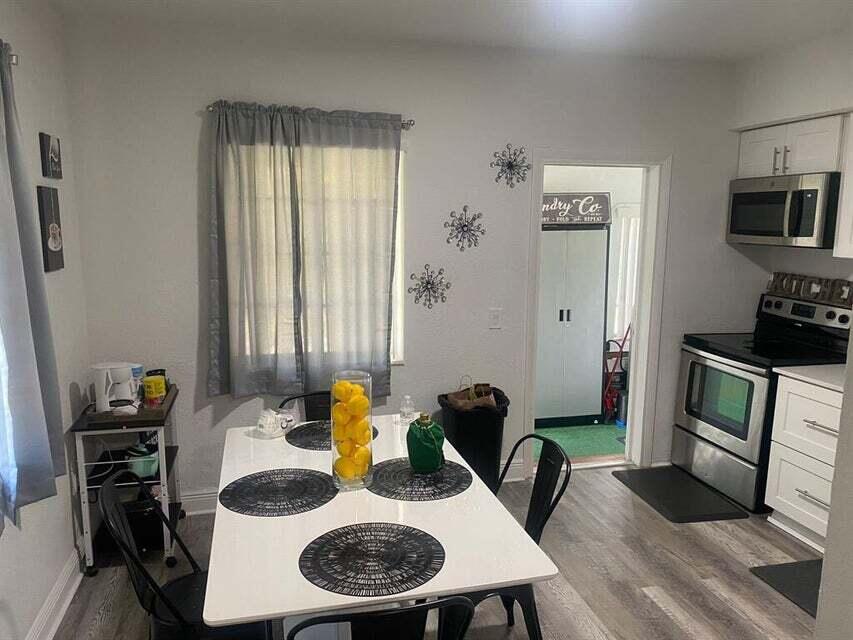 538 Southwest 7th Street Hallandale Beach, FL 33009 - Photo 17 of 17 a dining room with furniture and wooden floor