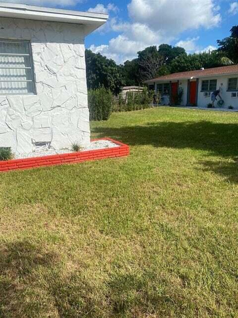 538 Southwest 7th Street Hallandale Beach, FL 33009 - Photo 4 of 17 a view of a backyard with plants and a garden