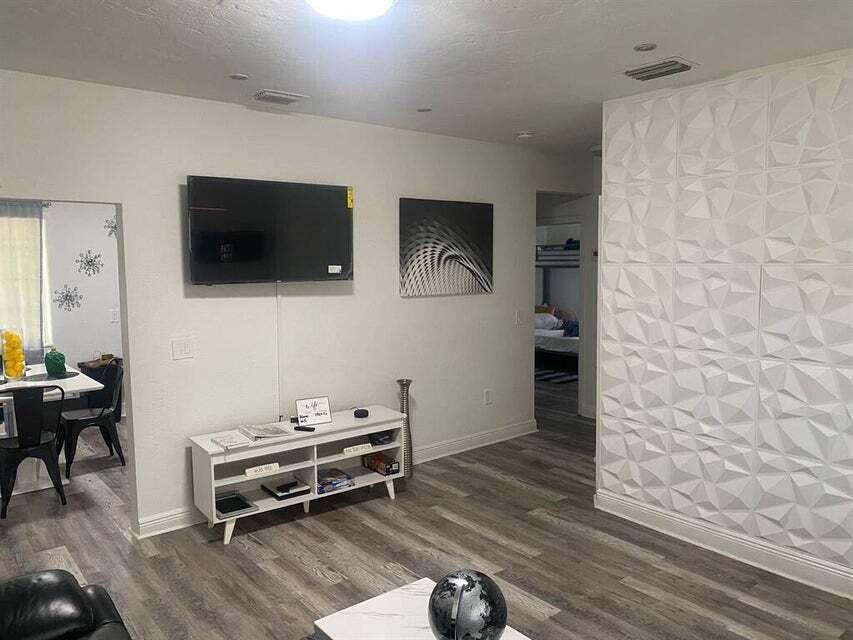 538 Southwest 7th Street Hallandale Beach, FL 33009 - Photo 5 of 17 a living room with furniture and a flat screen tv