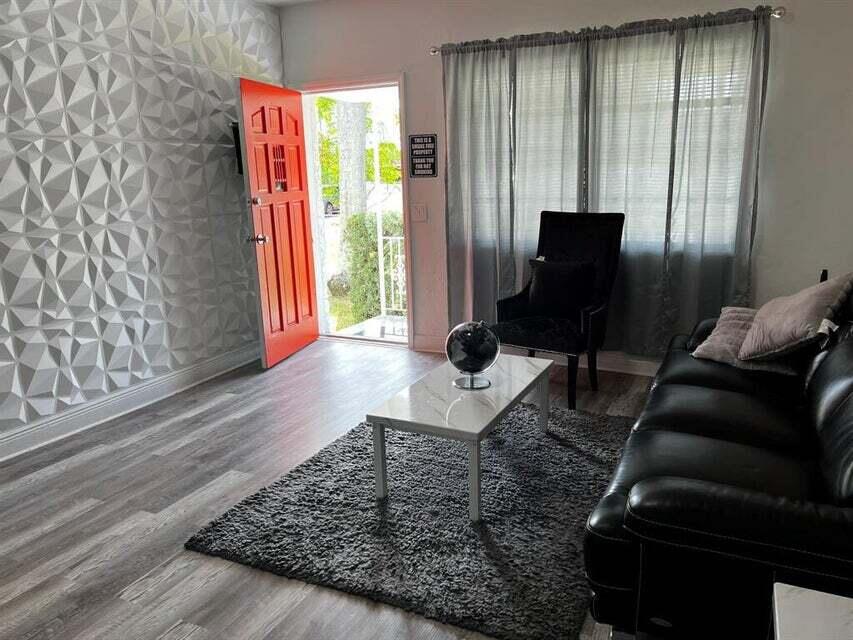 538 Southwest 7th Street Hallandale Beach, FL 33009 - Photo 6 of 17 a living room with furniture and a floor to ceiling window