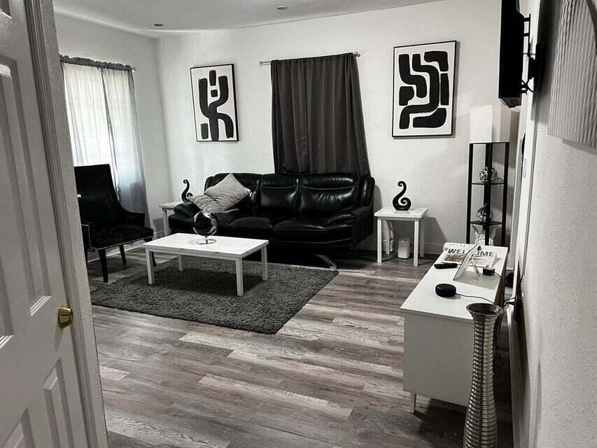 538 Southwest 7th Street Hallandale Beach, FL 33009 - Photo 9 of 17 a living room with furniture and a mirror