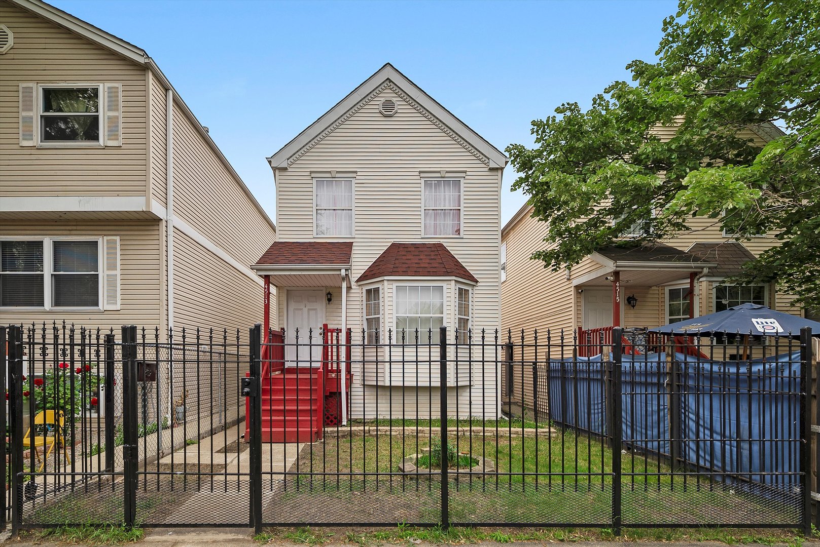 4513 South Wood Street Chicago, IL 60609 - Photo 3 of 3 a front view of a house with iron fence