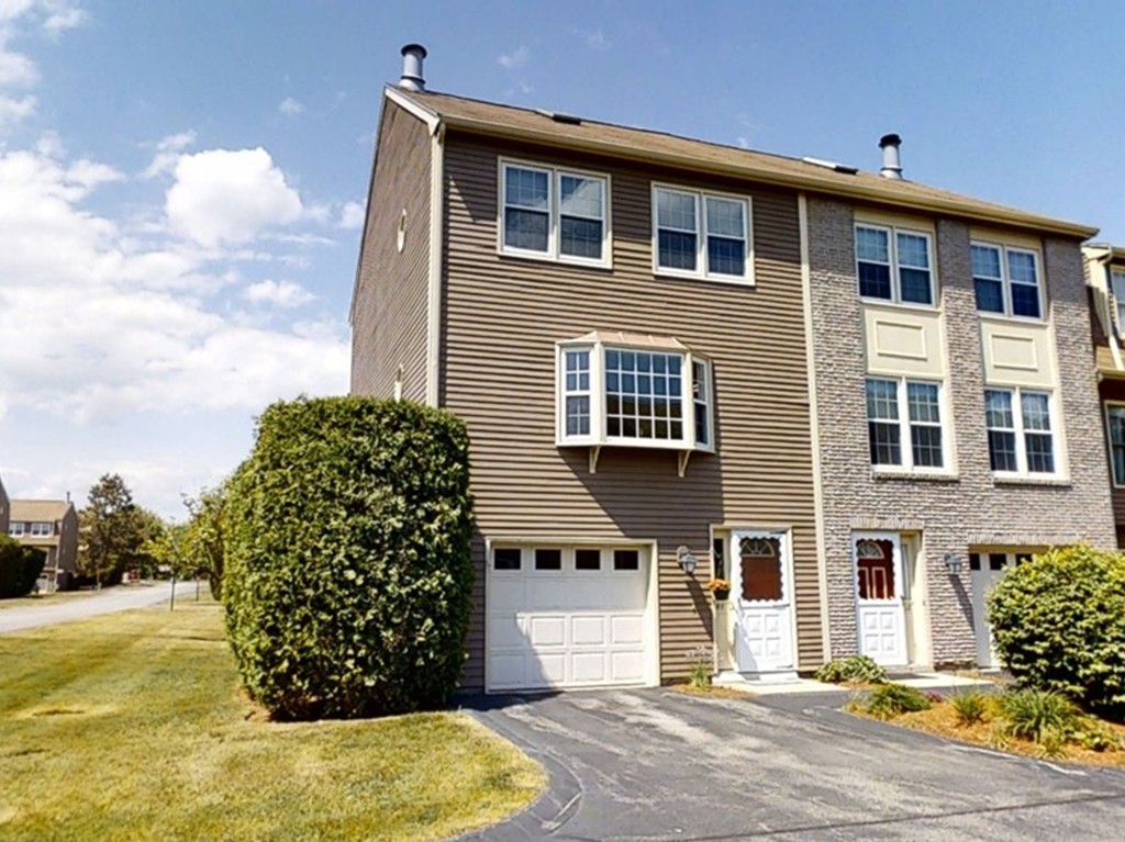 61 Heritage Drive, Unit 61 Tewksbury, MA 01876 - Photo 1 of 35 a front view of a house with a garden