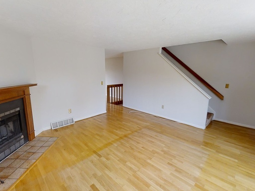 61 Heritage Drive, Unit 61 Tewksbury, MA 01876 - Photo 12 of 35 a view of empty room with wooden floor and fireplace