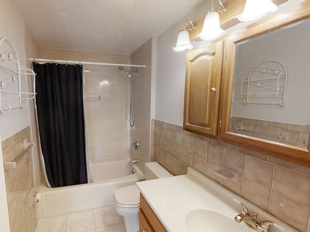 61 Heritage Drive, Unit 61 Tewksbury, MA 01876 - Photo 16 of 35 a bathroom with a bathtub shower sink vanity and toilet