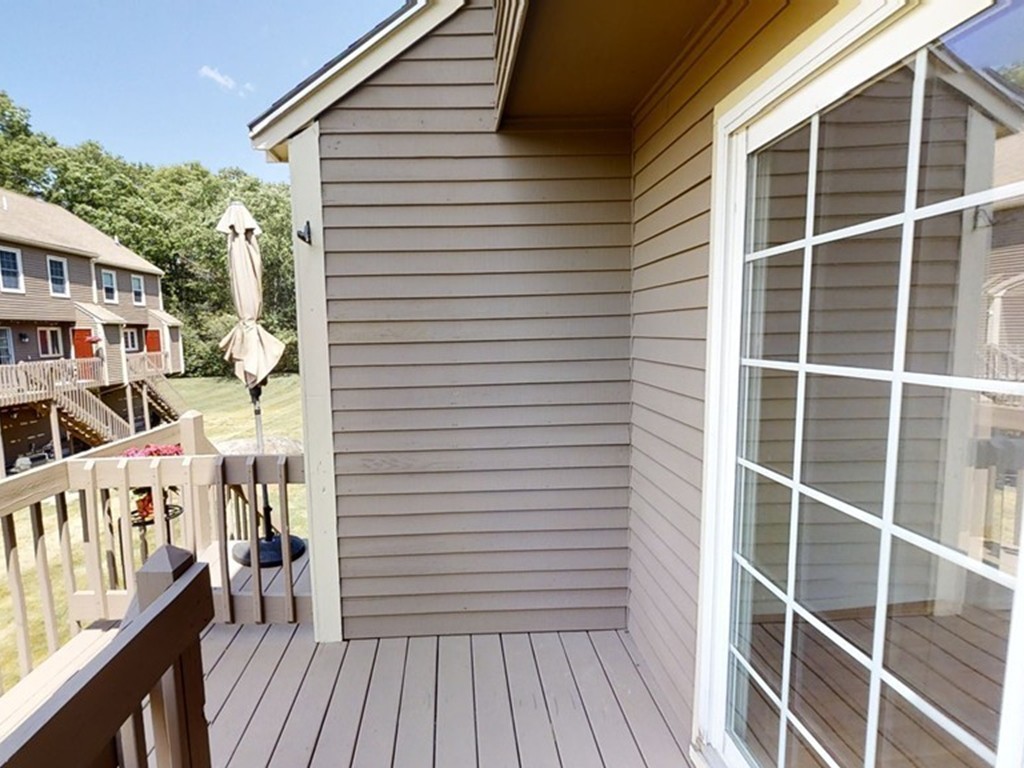 61 Heritage Drive, Unit 61 Tewksbury, MA 01876 - Photo 23 of 35 a view of a house with a deck