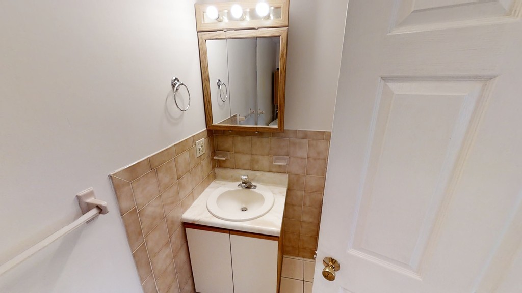 61 Heritage Drive, Unit 61 Tewksbury, MA 01876 - Photo 27 of 35 a bathroom with a sink and mirror