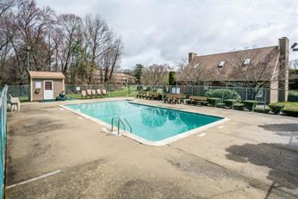 61 Heritage Drive, Unit 61 Tewksbury, MA 01876 - Photo 30 of 35 a view of a swimming pool and a yard