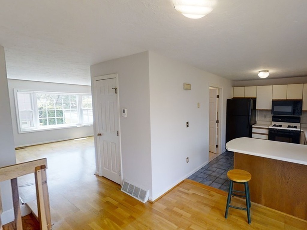 61 Heritage Drive, Unit 61 Tewksbury, MA 01876 - Photo 10 of 35 a view of kitchen with wooden floor and electronic appliances