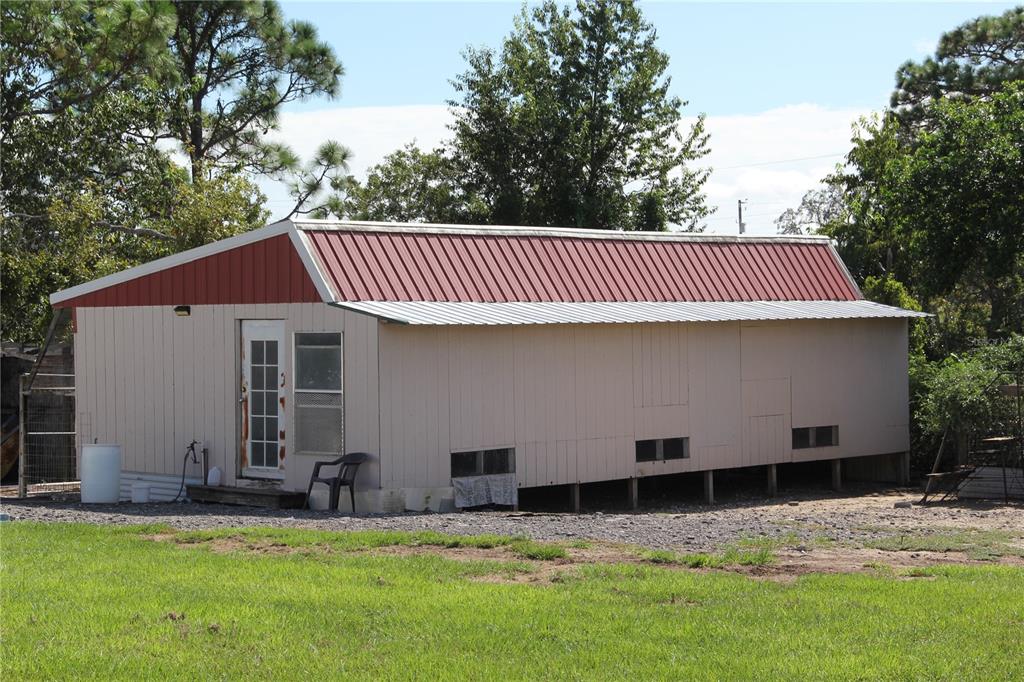 13127 Star Road Brooksville, FL 34613 - Photo 53 of 54 a view of a house with a yard