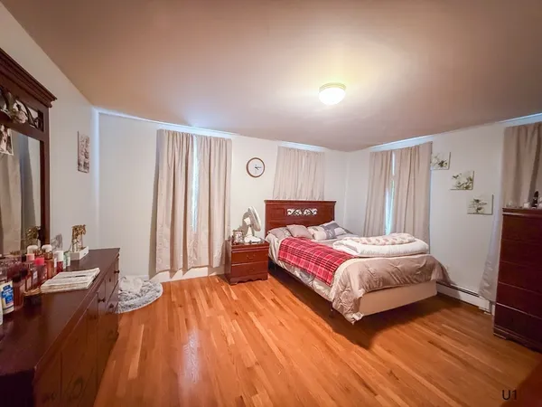 a bathroom with a sink a toilet and shower curtain