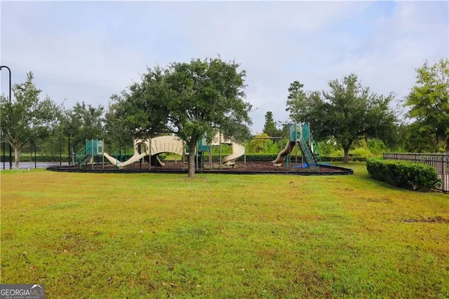 a view of pool with table and chairs under an umbrella