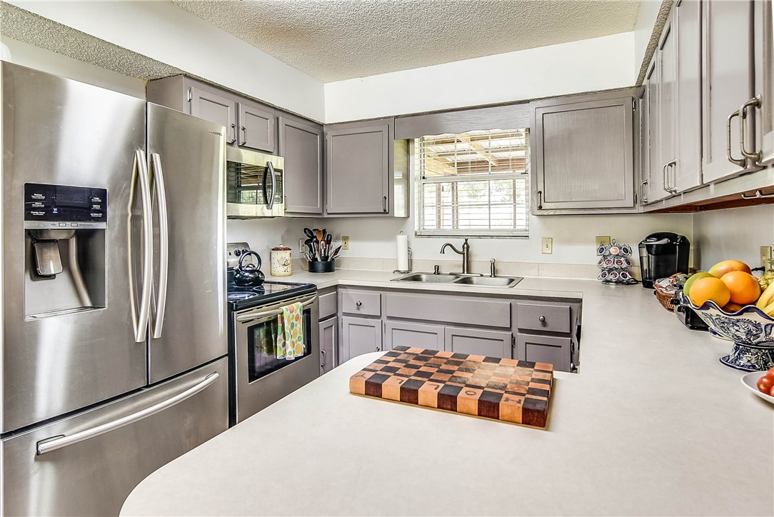 54014 Vikki Road Callahan, FL 32011 - Photo 3 of 29 a kitchen with stainless steel appliances a refrigerator and a sink